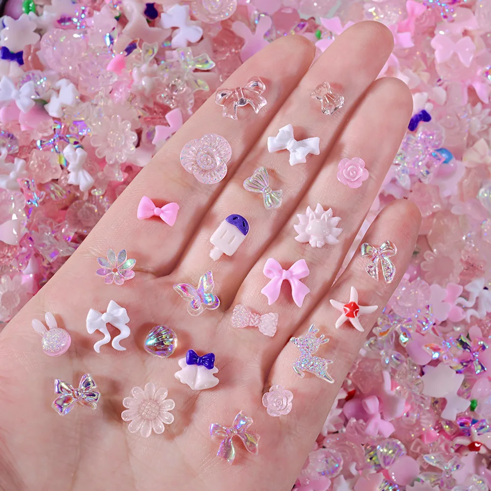 

50g/Bag Random Mixed Nail Art Charms Aurora Ribbon Pink Bow Transparent Star Butterfly Flower Nail Decorations for Fake Nail DIY