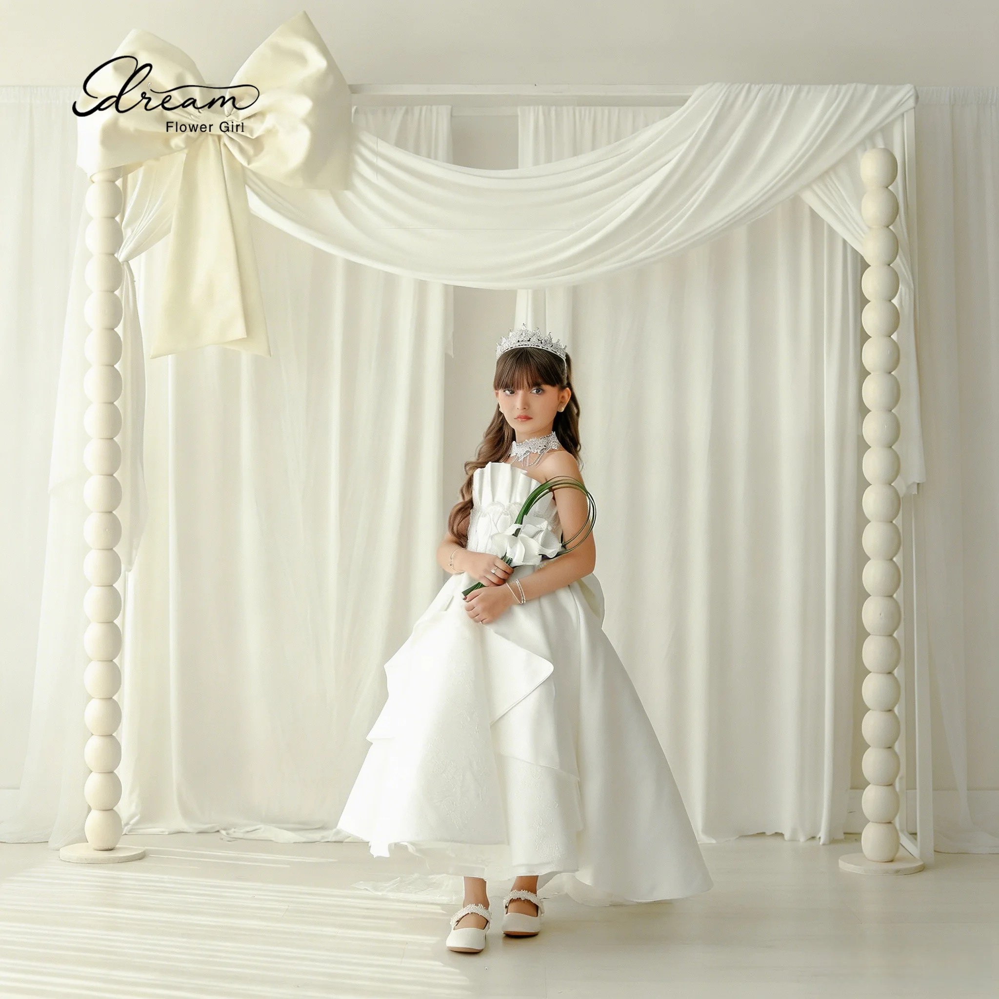 Elegant white long formal ball gown, strapless, plunging neckline with a bow, fluffy skirt, adorned with embroidery