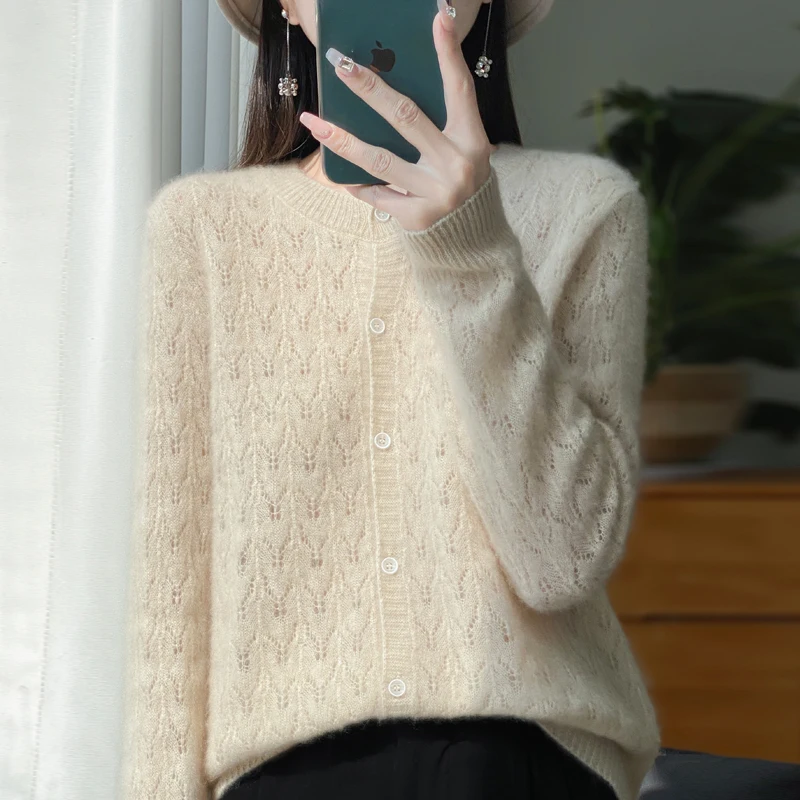 Autumn and winter new 100% pure wool cardigan female O-neck hollow crocheted solid color long sleeve sweater loose sweater coat.