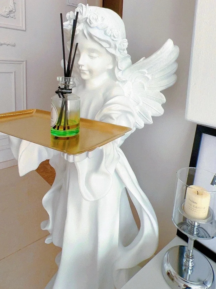 The little angel on the tray, a large floor standing statue