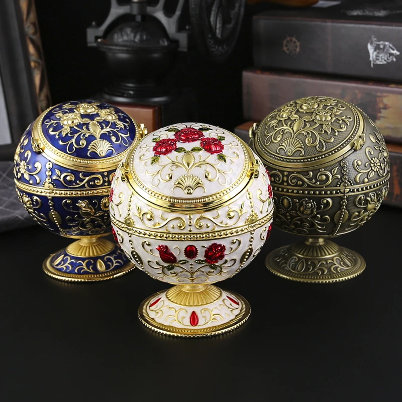 

1 globe shaped metal ashtray with dust resistant design and cover, suitable for living rooms and office desktops.