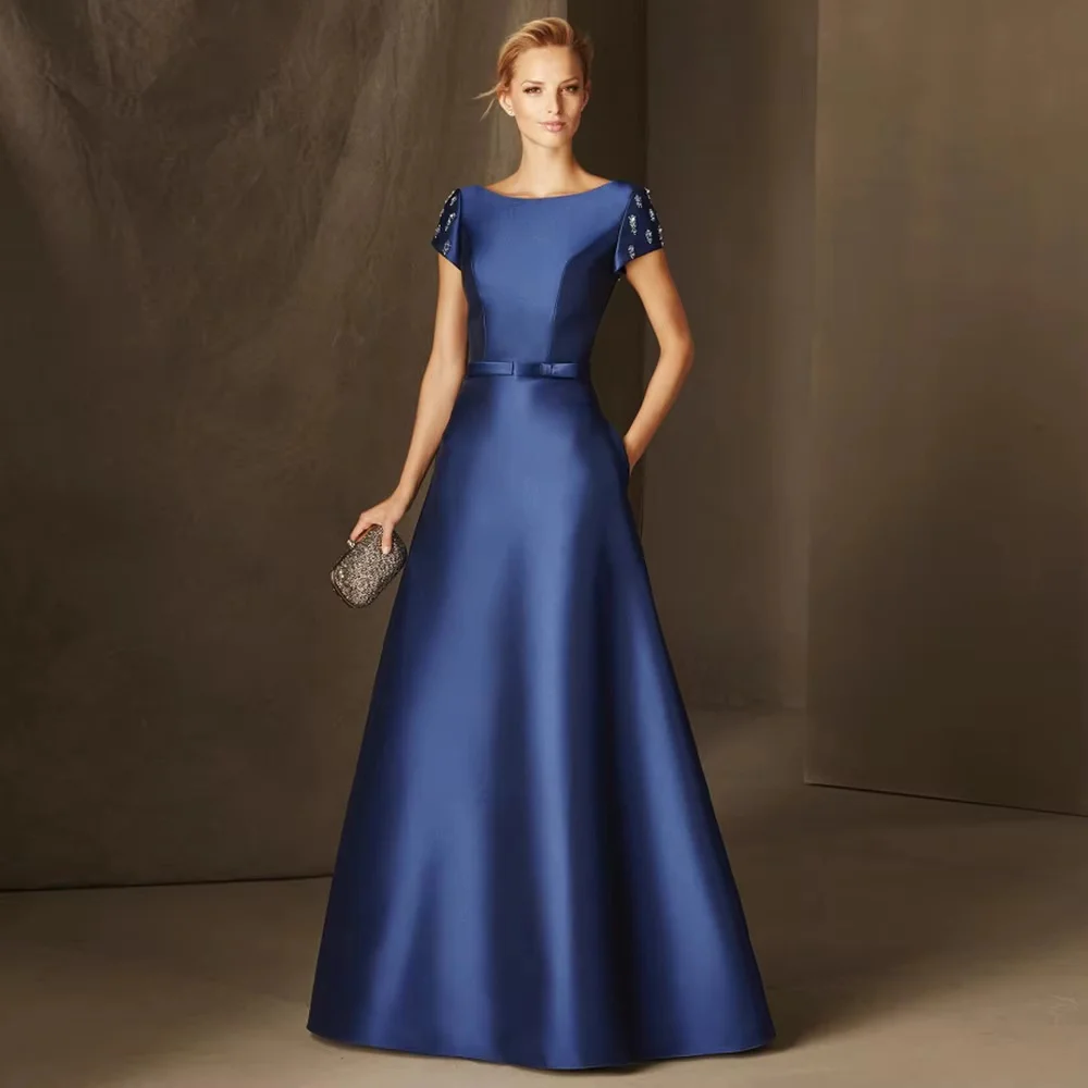 Off-shoulder short sleeve satin floor-length gown. Fitted waist and full skirt with elegant sheen. Custom sizes available for ba