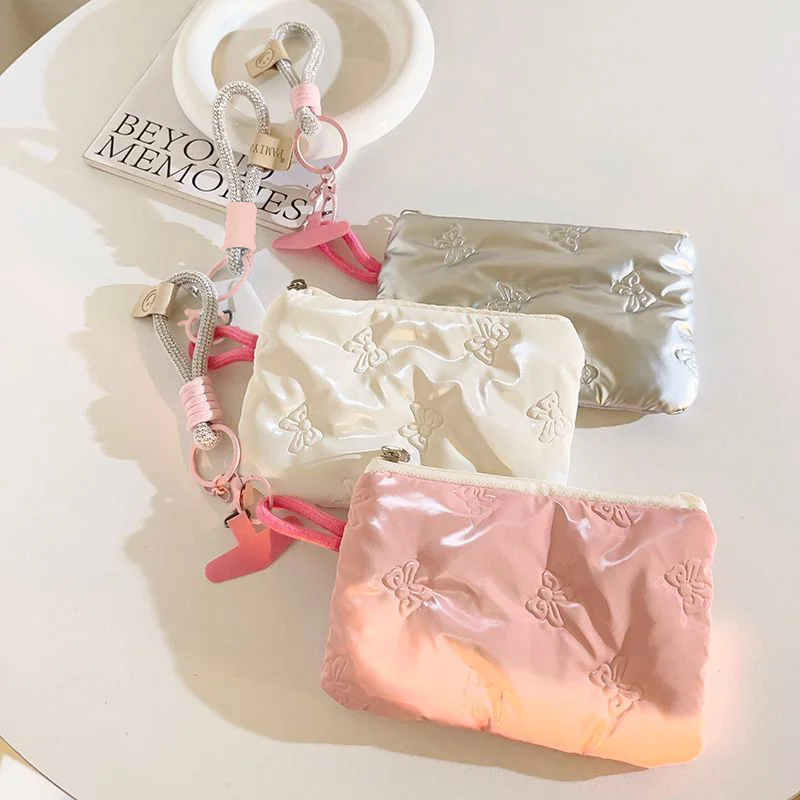 Embossed bow coin purse with phone lanyard, holds lipstick, earbuds, coins & keys, girly pink, must-have for stylish girls.