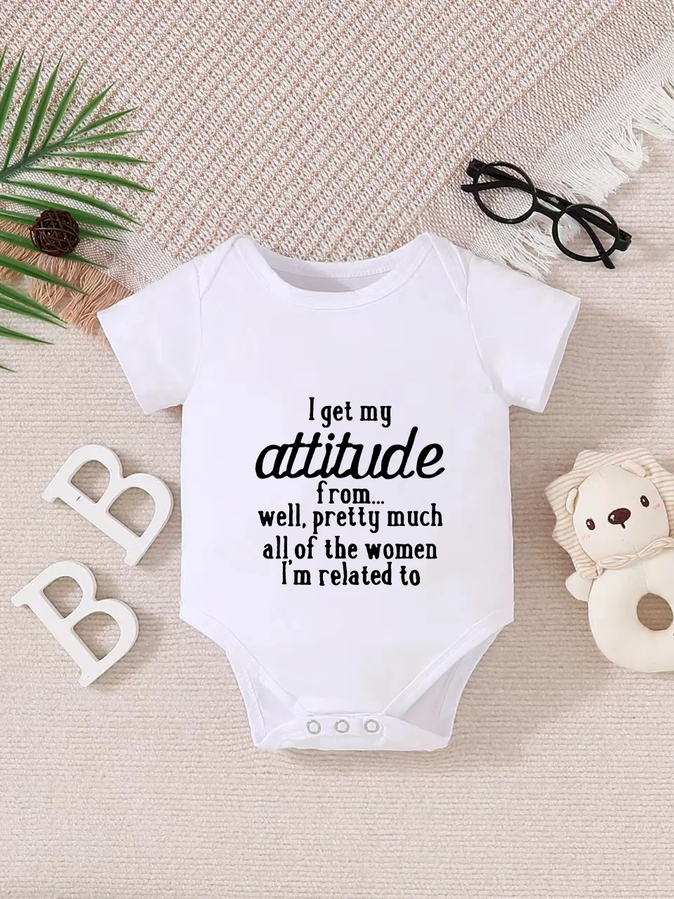 Playful letter-printed baby short-sleeve triangle bodysuit. Button closure for easy dressing, machine washable