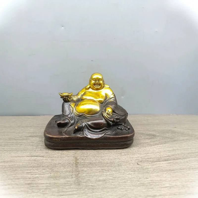 Various copper ornaments, Laughing Buddha figurines, antique collectibles, home decor items, and decorative crafts