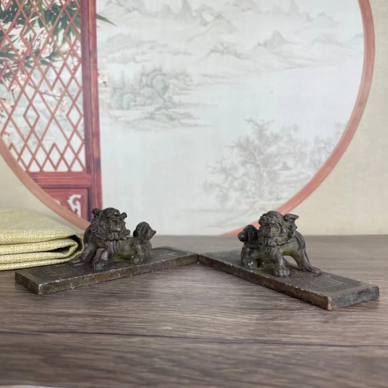 A pair of copper lion paperweights rulers, symbolizing virtue and capacity, decorative pieces