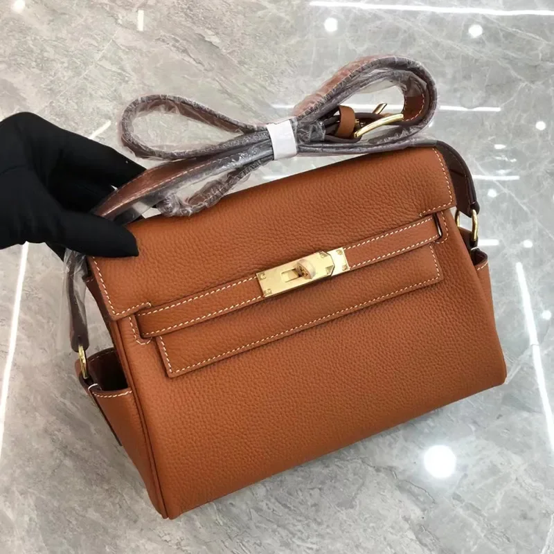 2025 nuevo bolso de mensajero Kelly capa superior de cuero de grano Litchi moda un solo hombro inclinado Cruz hebilla de bloqueo de mano hoja genuina