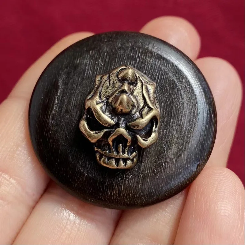 Donkey hoof inlaid with brass featuring a corpse-removing deity charm a safety buckle a circular pendant and a bread-shaped