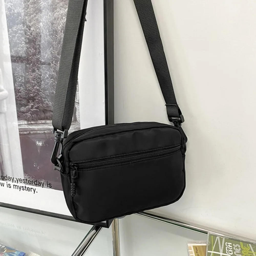 Bolsos cruzados informales ligeros para hombre, bolso deportivo portátil de estilo japonés para teléfono, bandolera de nailon con cremallera de Color sólido, Unisex