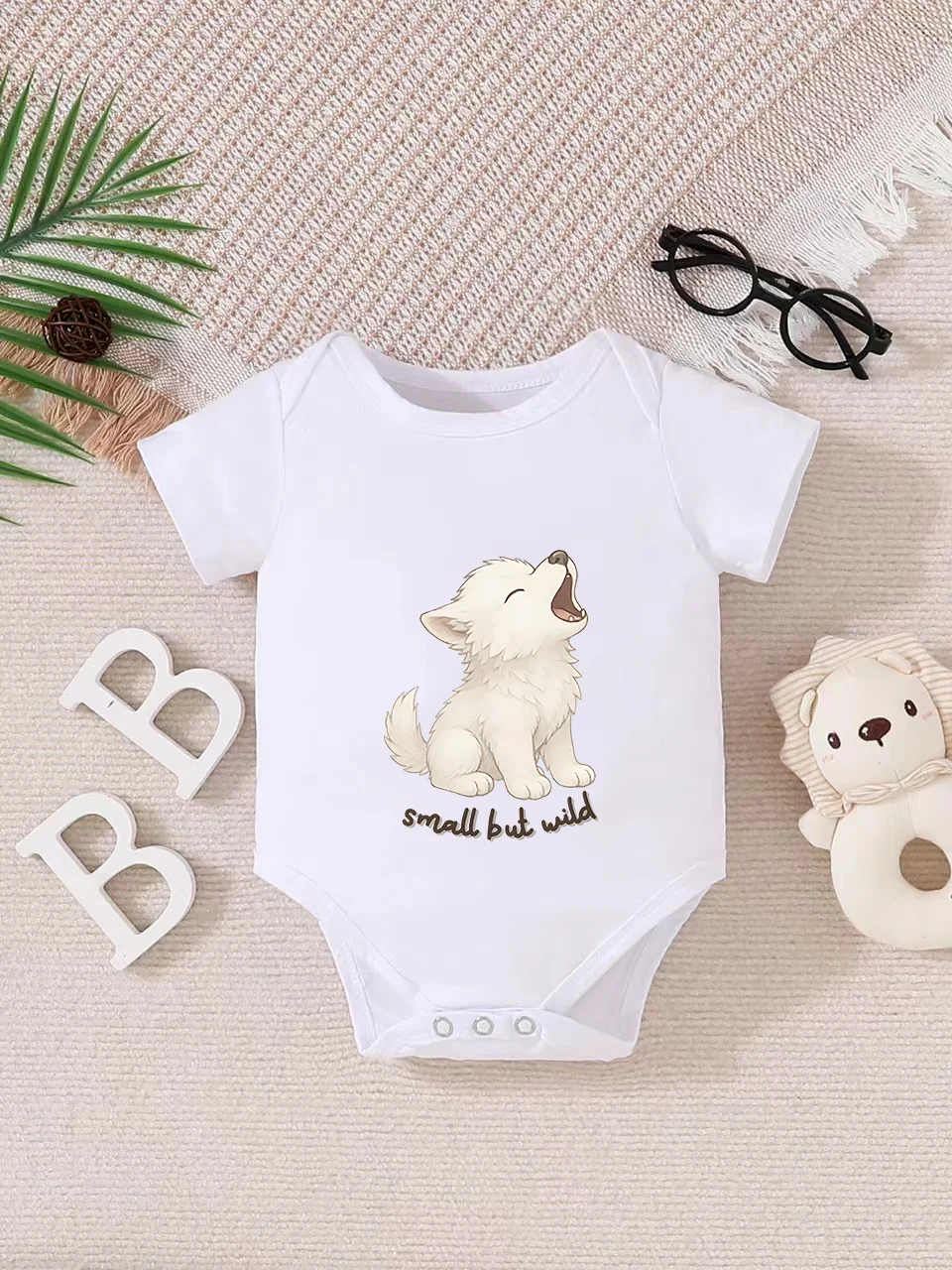 Playful letter-printed baby short-sleeve triangle bodysuit. Button closure for easy dressing, machine washable