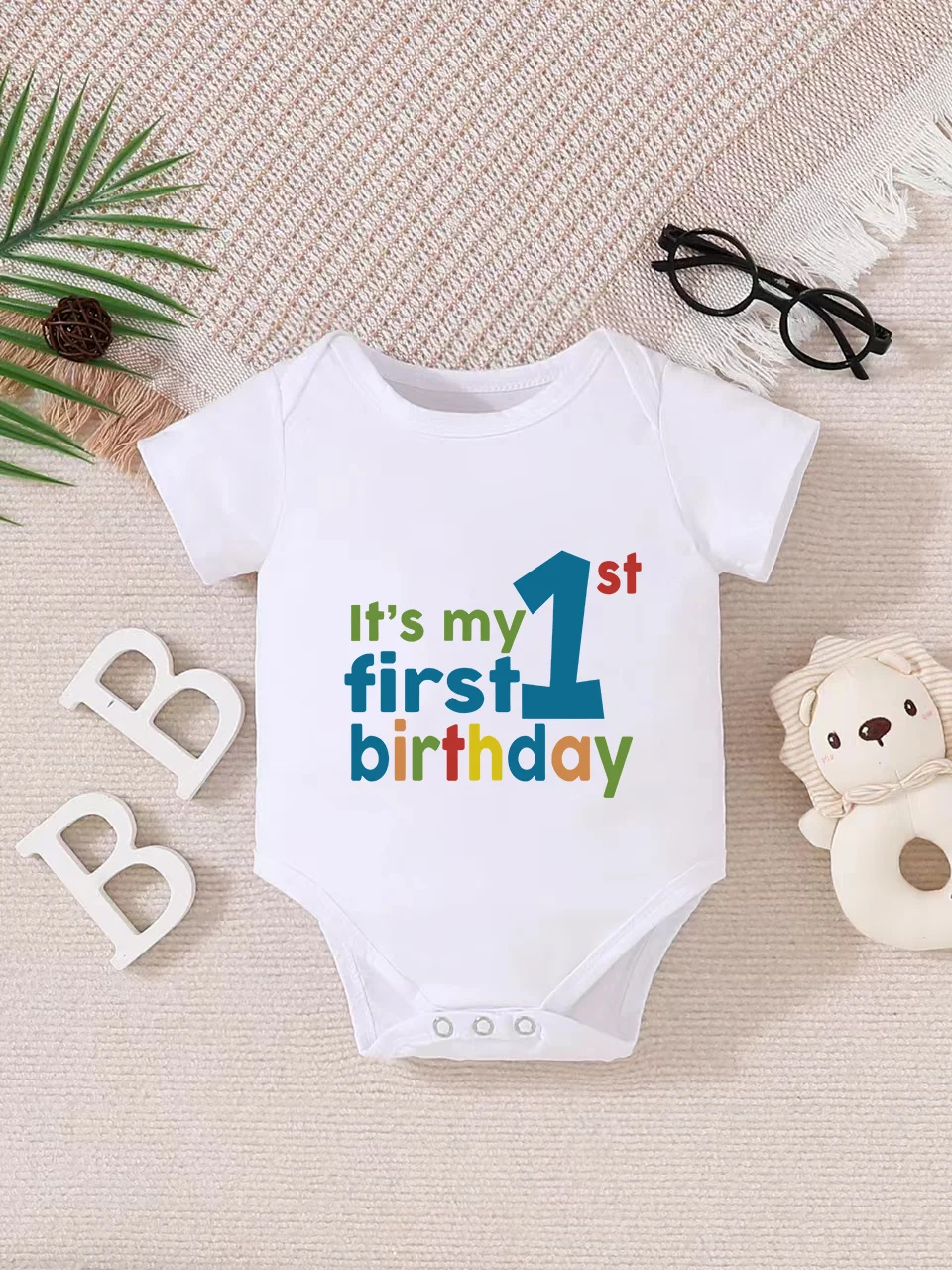 Playful letter-printed baby short-sleeve triangle bodysuit. Button closure for easy dressing, machine washable