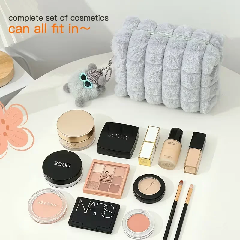 Large-capacity plush makeup bag with fluffy pendant - A soft-touch pink makeup bag, suitable for travel and household use.