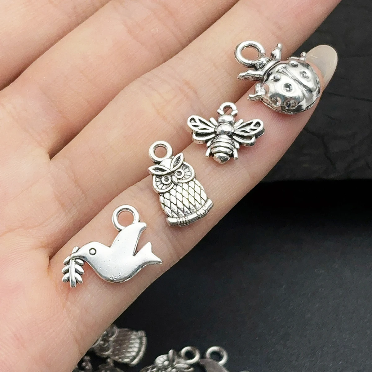 24-Piece Set of DIY Handmade Accessories, Featuring Seven-Star Ladybugs, Wood-Grain Owls, Peace Doves Holding Branches, and Little Bees in Various Designs, Suitable for DIY Bracelets, Necklaces, Earrings, Pendants, and Handmade Beaded Decoration Accessories