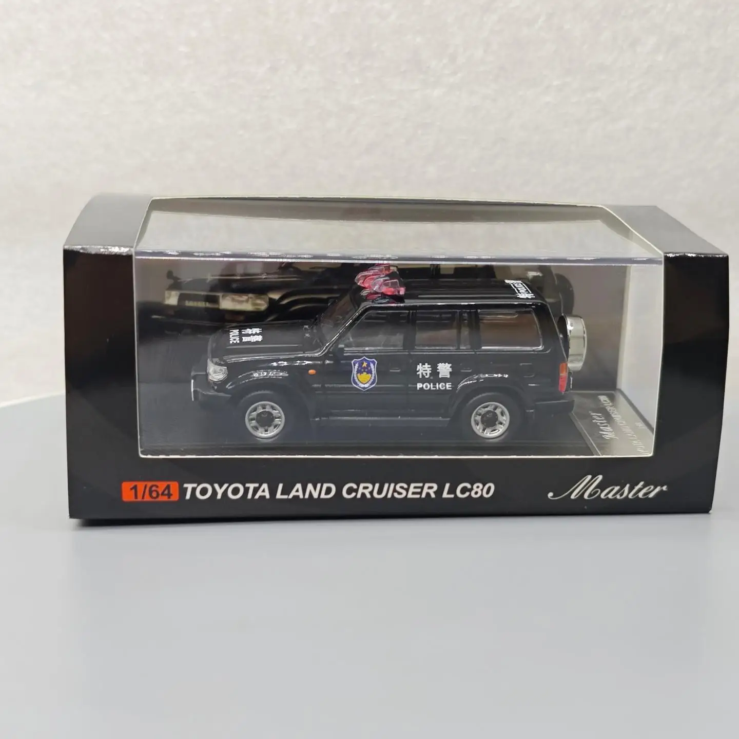 รถโมเดลจำลองโลหะผสม แลนด์ครุยเซอร์ LC80 รุ่นตำรวจพิเศษ ขนาด 1:64 ของสะสม ของเล่น