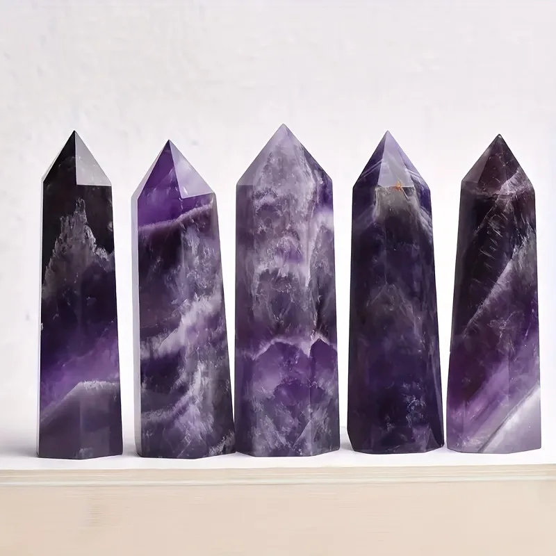 A single, stunning, dreamy amethyst wand with a beveled amethyst tip, scattered gemstones, and a bohemian style