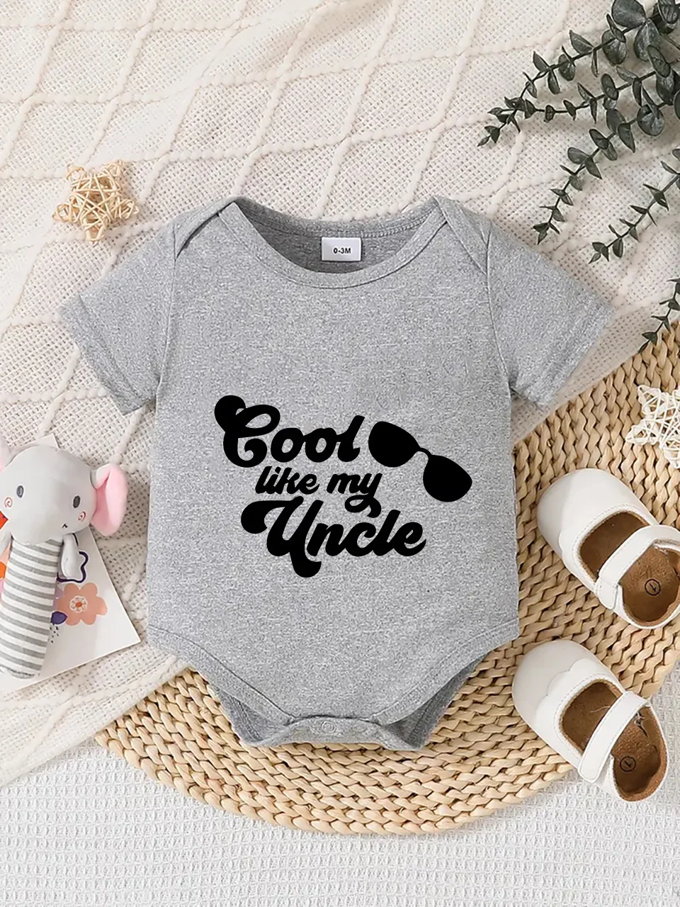 Playful letter-printed baby short-sleeve triangle bodysuit. Button closure for easy dressing, machine washable