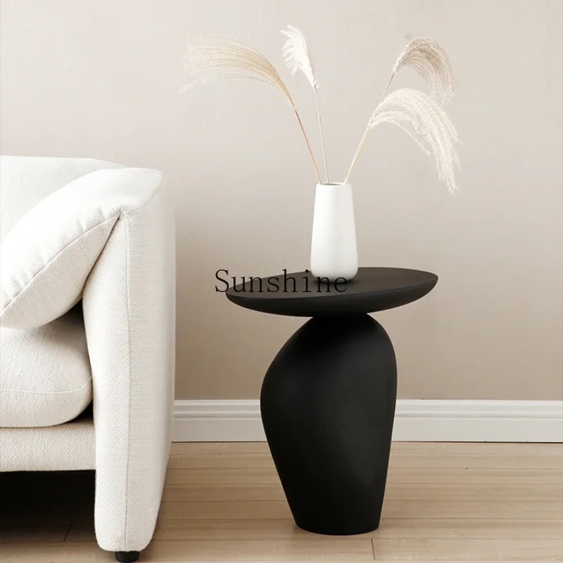 Minimalist sofa corner few black pebble small coffee table