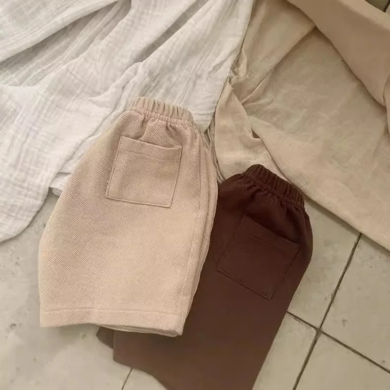 Vestiti del bambino tinta unita semplice tutto abbinato pantaloncini 2024 autunno nuovo stile coreano ragazzi e ragazze pantaloni Casual moda bambino