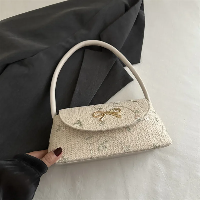 Korean version of fashionable versatile straw woven bag women's high-end bow thorn shoulder embroidered armpit bag