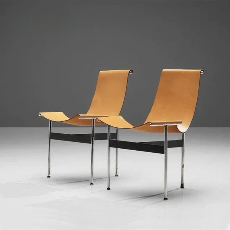 

Industrial Chic Dining Chair: A Modern Stainless Steel Frame with Saddle Leather Seat, Inspired by Medieval Design Principles