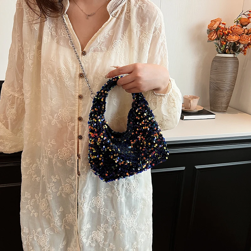 A shoulder bag made of sequins, sparkly, multi-colored, delicate and small