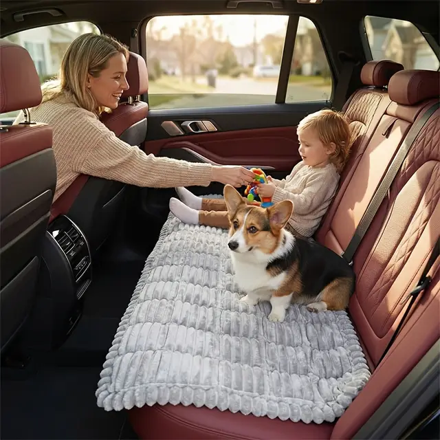 Corgi sitting on the PawRide mat on a back seat next to a child