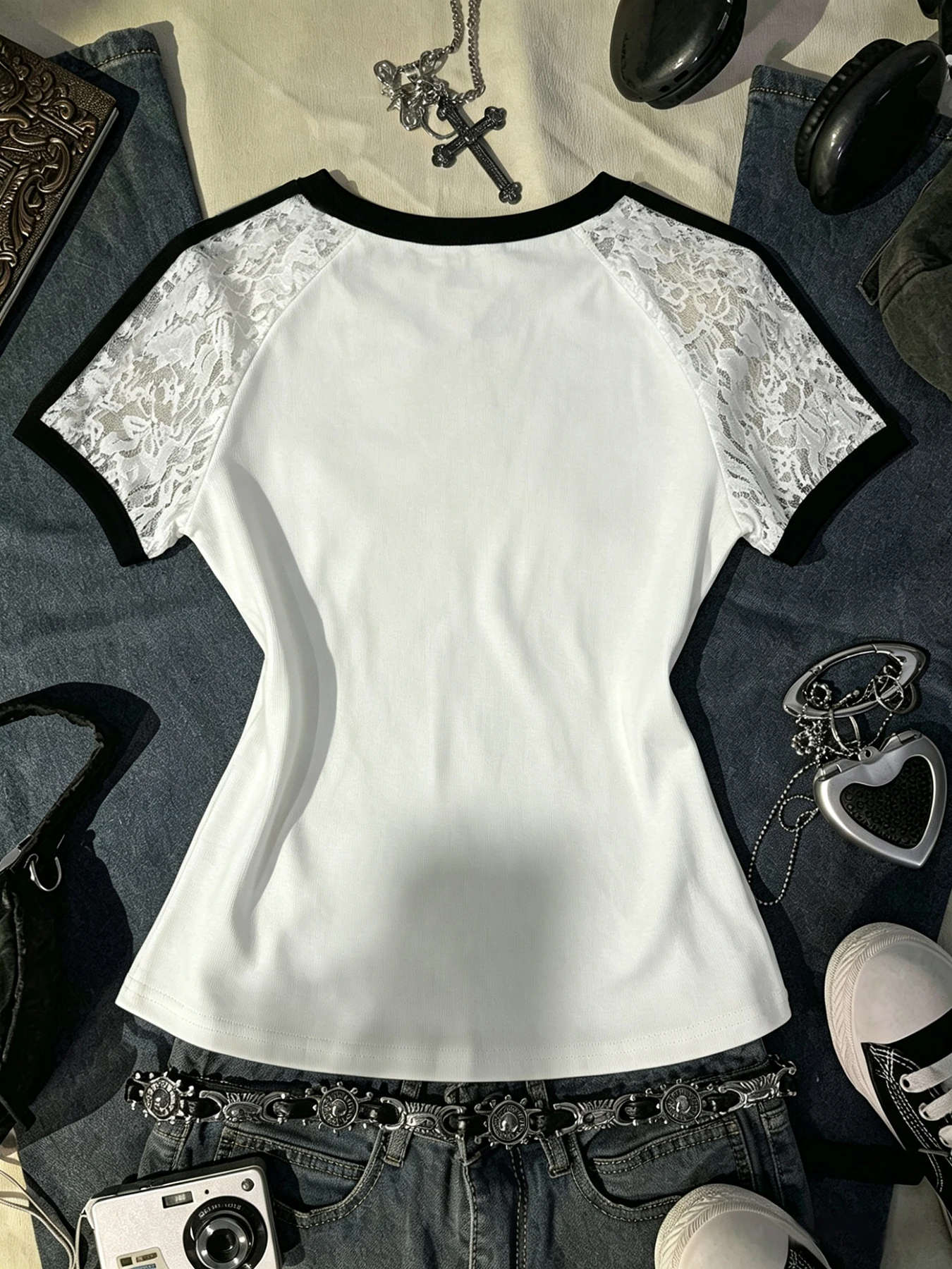 Women's white short-sleeved T-shirt with lace trim on the sleeves and embroidered cross pattern.