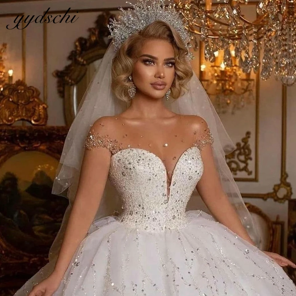 

2025 Sexy Exquisite V-Neck Long Sleeves Ball Gown Wedding Dress Sparkly Crystal Appliques Backless Beading Bridal Gown For Women
