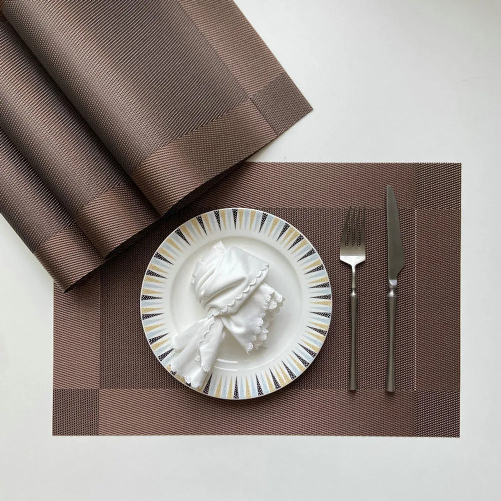 

Set of four placemats offering protection against heat and spills for use in dining areas kitchens and restaurants