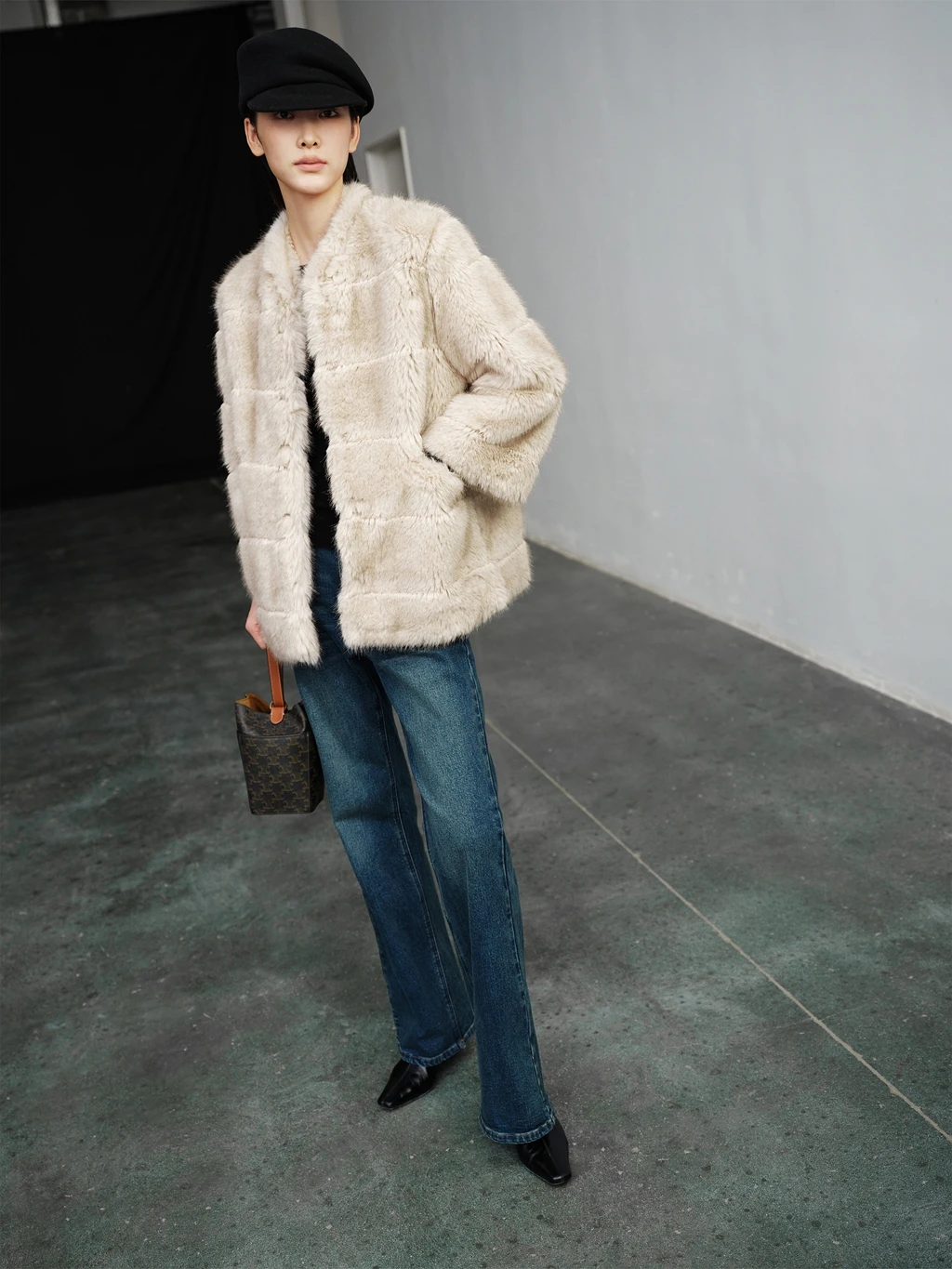 A slim and eco-friendly fur coat made of faux mink with 9-quarter sleeves
