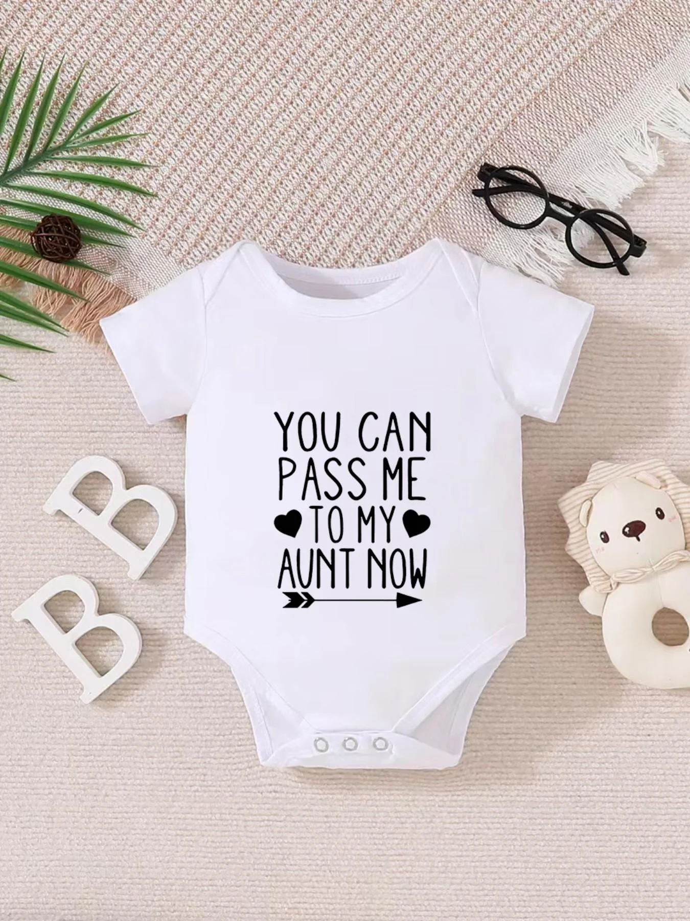 Playful letter-printed baby short-sleeve triangle bodysuit. Button closure for easy dressing, machine washable