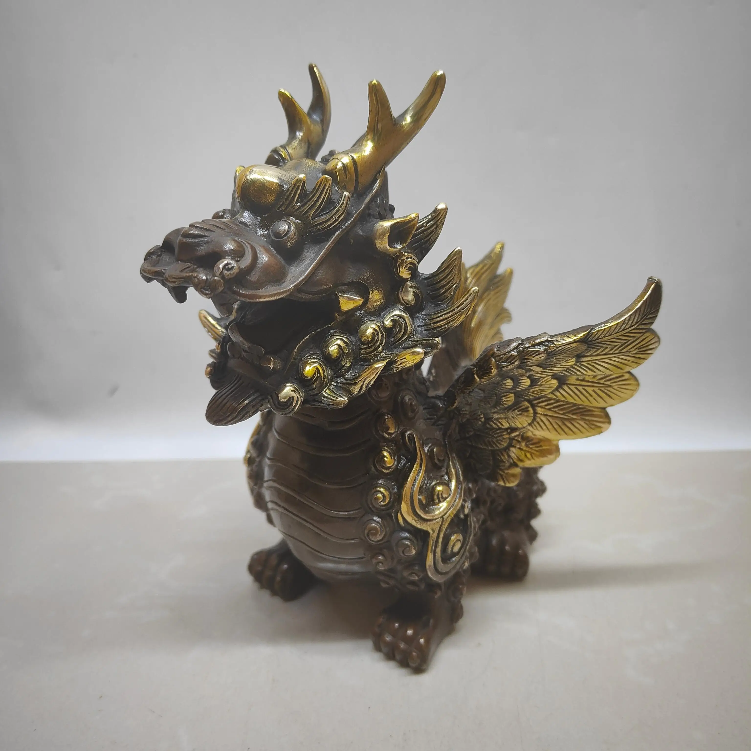 

A small flying qilin made of brass that imitates purple copper with gilded antique craftsmanship.,Free shipping