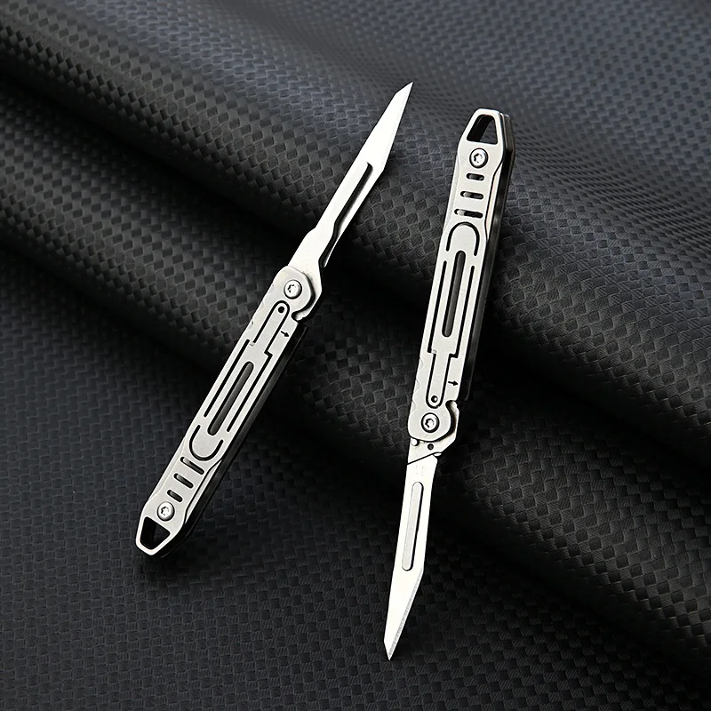 ใหม่ Mini Titanium Alloy มีดพับกลางแจ้ง Camping แบบพกพา EDC มีดมาพร้อมกับใบมีดฟรี 10 ชิ้น