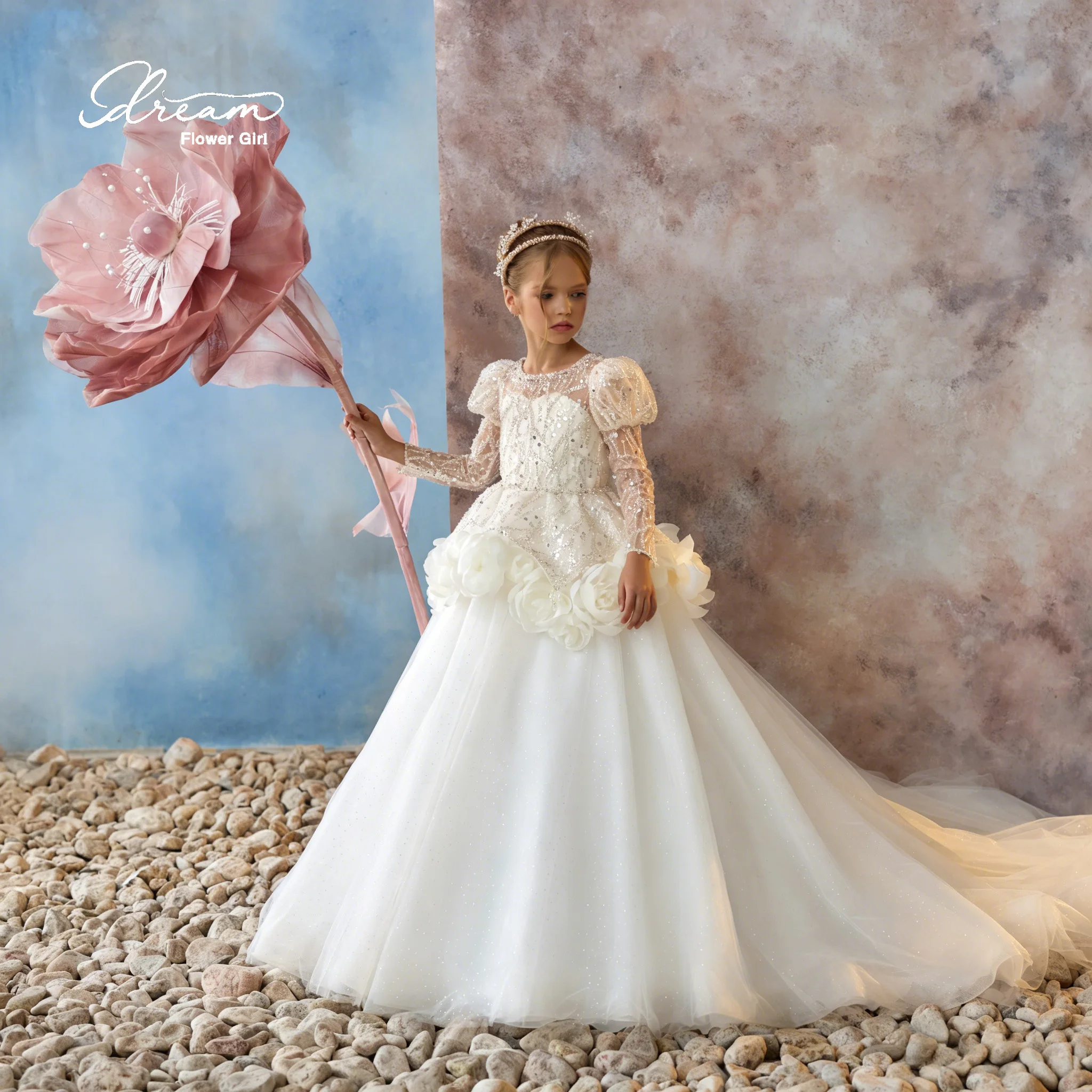 

A beautiful backless, full-skirted evening dress with floor-length hem, featuring lace, sequins, strap bows and flower designs.