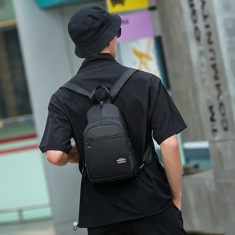 Mini Mochila pequeña de lona para hombre, bolso escolar de hombro, impermeable, para viaje, color negro, 2023