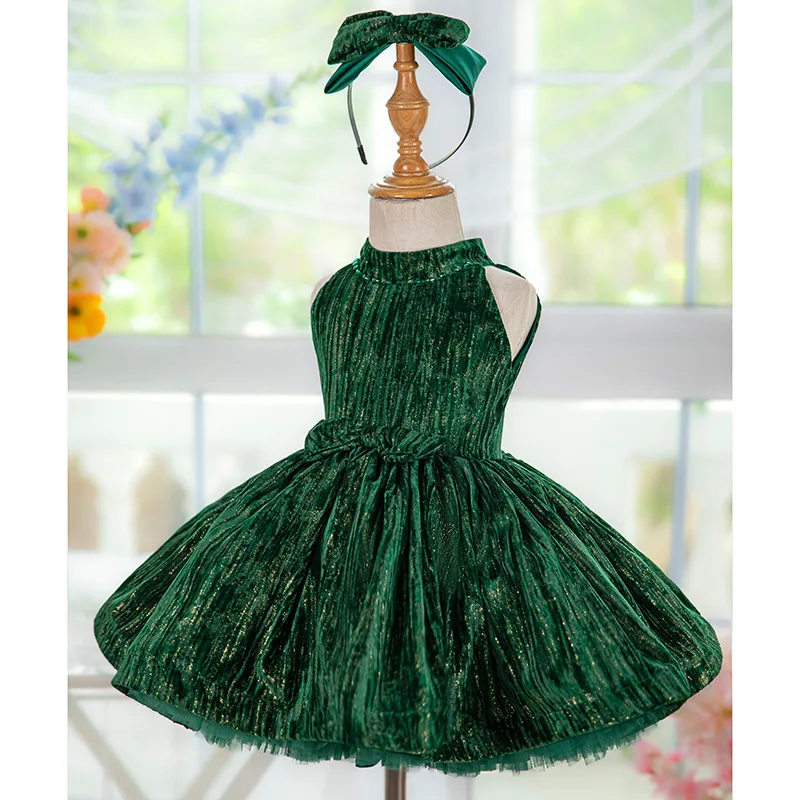 Stylish and luxurious dark green baby girl dress in sparkling velvet fabric suitable for a first birthday party New Year dress