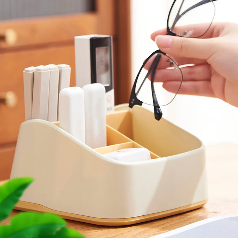 Żółty organizer na biurko, wielofunkcyjny pojemnik na artykuły piśmiennicze, porządkujący środowisko domowe, mały, elegancki design.