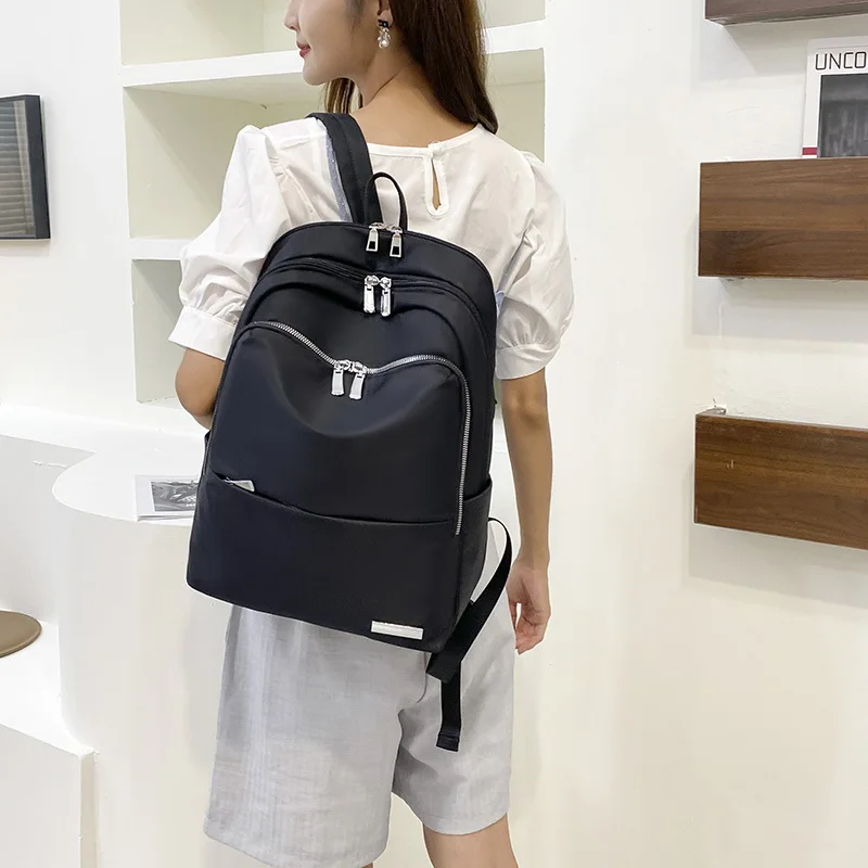 Fashion laptop bag lightweight commuter backpack ladies Joker summer new Oxford cloth travel backpack large capacity.