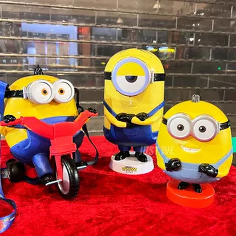 Minions with big eyes surrounded by water cups shaped cups Otto riding bikes popcorn buckets shoulder bags toys children's gifts