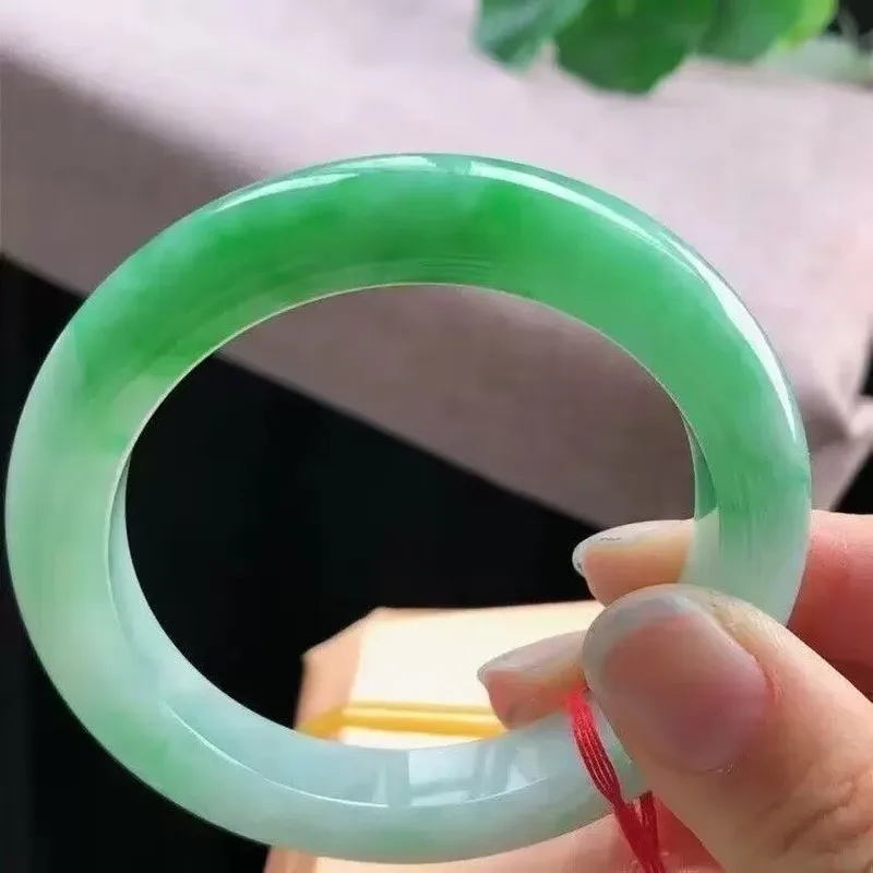 jadeite   ice-type  with floating inclusions  perfectly  oval-shaped  and round green jade bracelet