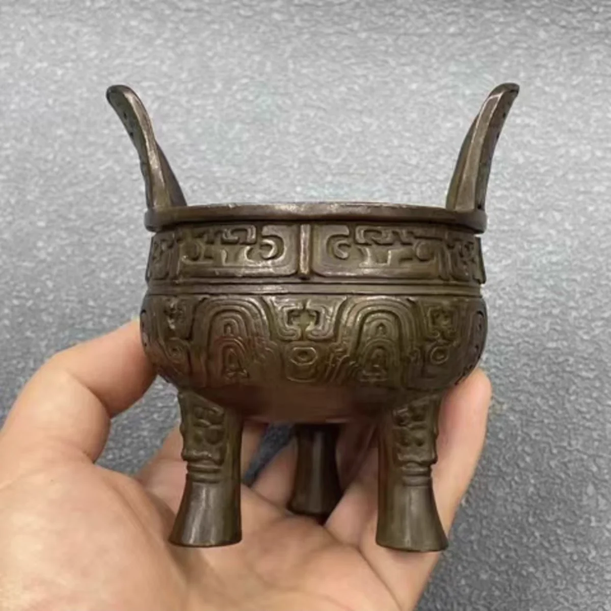 

Three legged bronze tripod with animal face decoration ear filling incense burner home decoration