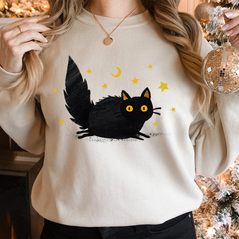 Felpa da donna alla moda con grafica gatto stelle e luna, occhi gialli, soffice gatto nero, tendenza, abbigliamento per ragazze, maglione gattino cartone animato