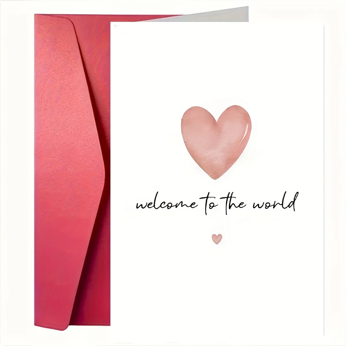 Une simple carte de félicitations pour un nouveau-né avec les mots « Bienvenue dans ce monde ».