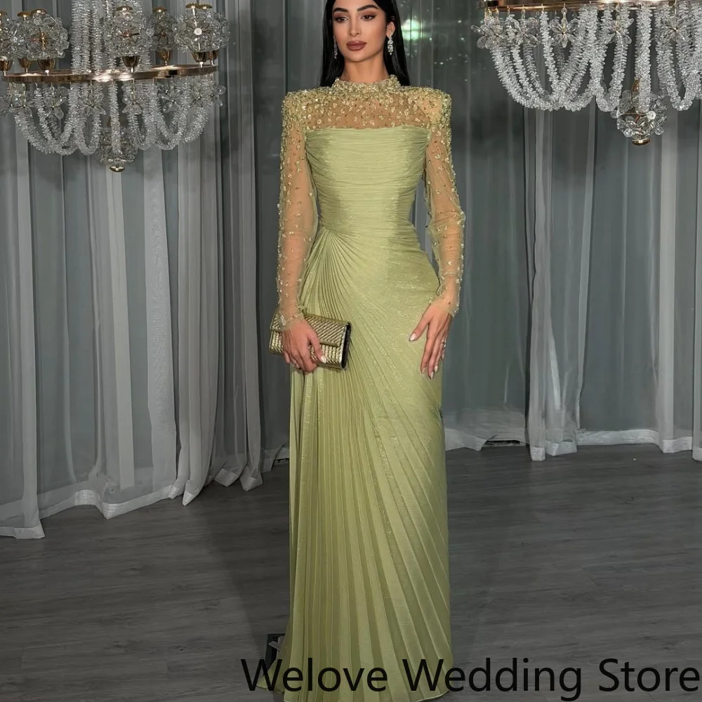Sage‑Green Formal Evening Gown Featuring High Neckline Sheer Long Sleeves With Intricate Beaded Detail Ruched Pleated Bodice