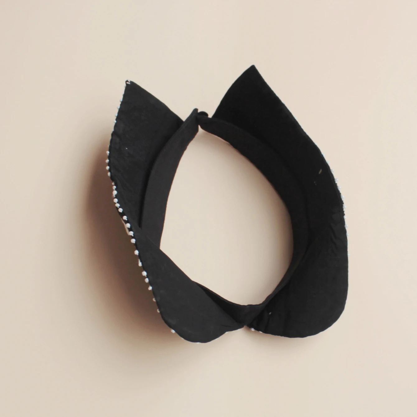 Fashion accessory, luxurious sequined false collar. Classic black background with white flowers. Inlaid with shining bead orname