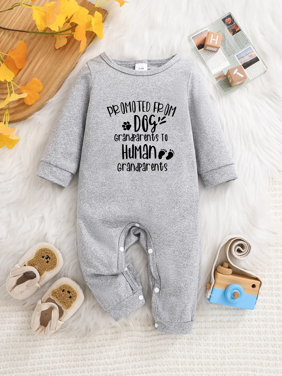 A baby long-sleeved onesie with interesting letter prints. It features a buttoned design for easy putting on and taking off