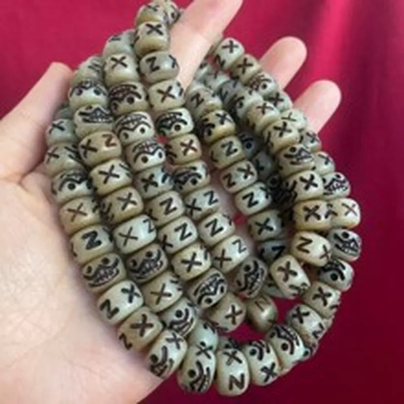 Tibetan-style cow bone bead with intricate carving featuring a meteorite pattern used for DIY jewelry and bracelet making