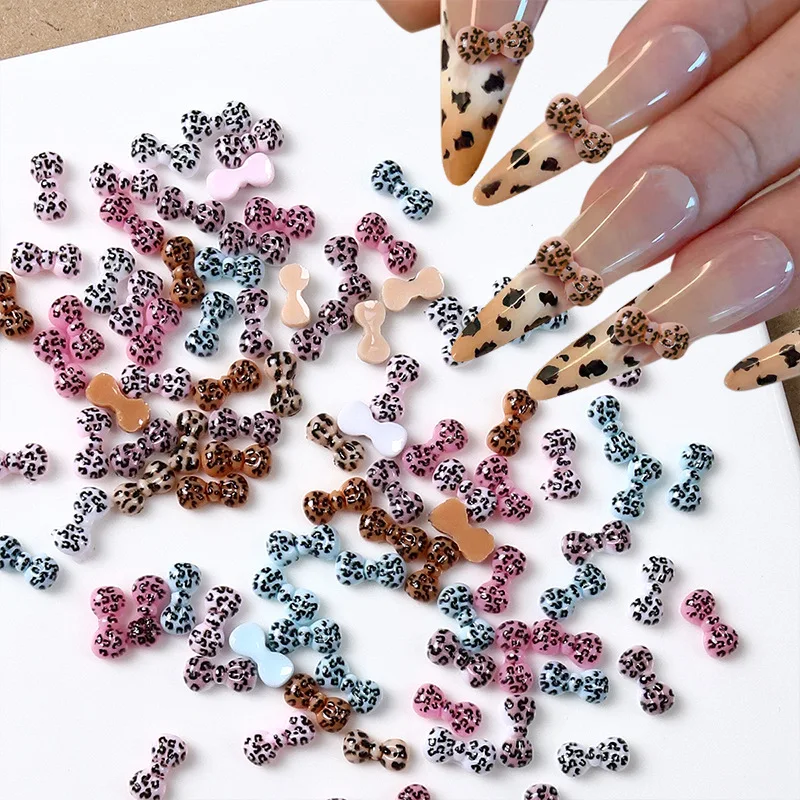 

100Pcs Hello Kitty Leopard Bow Nail Charms - 3D Animal Print & Ribbon Resin Nail Art for Edgy Kawaii Manicures