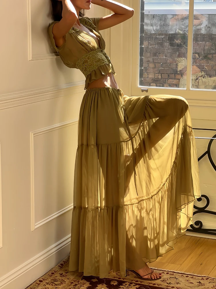 

Green women's matching sets, net-sheer blouse with elegant ruffled edges and a half-length skirt. 2026 new style women's suits.