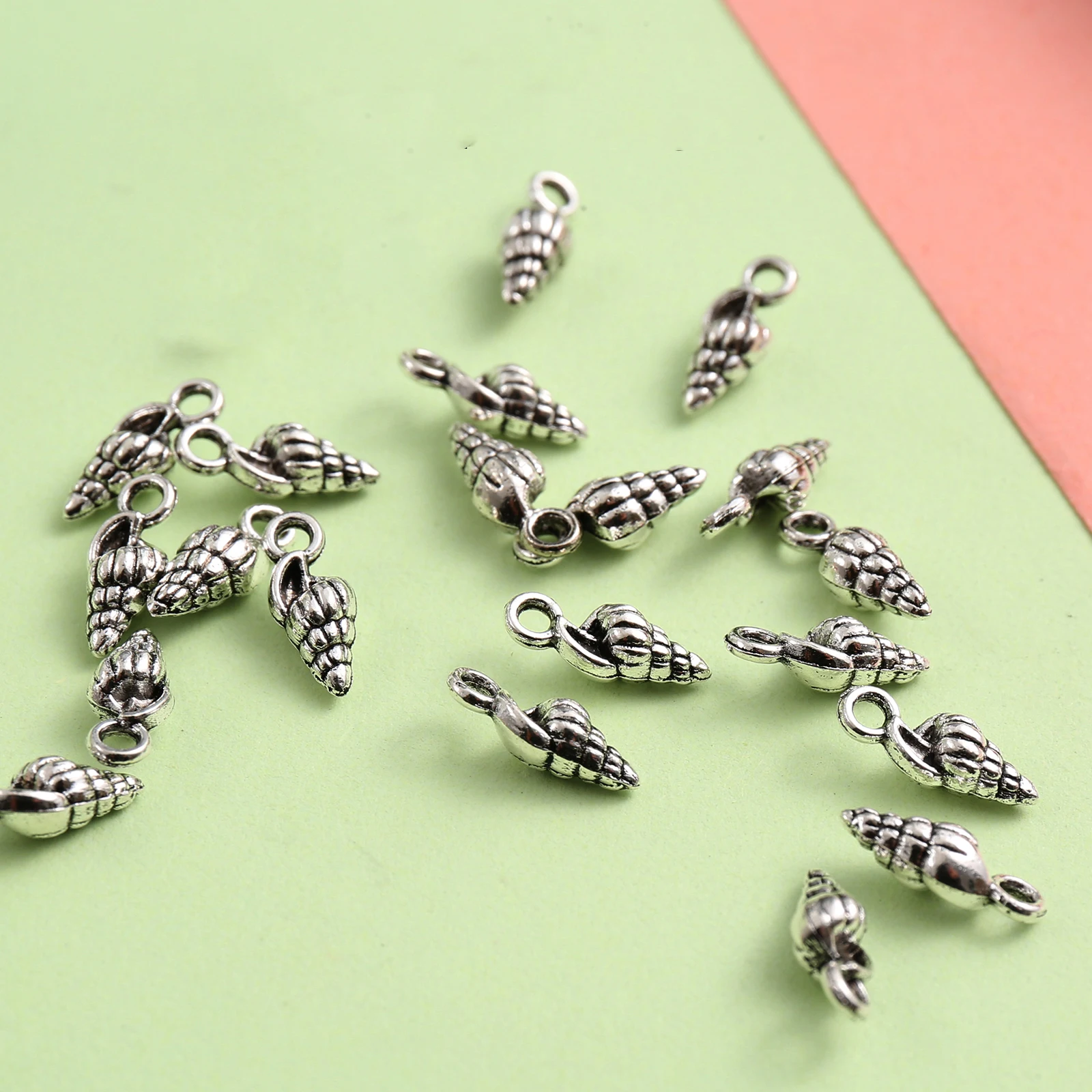 50 Mini Conch-Shaped DIY Handmade Pendants, with Spiral Texture That Replicates the Feel of Ocean Shells, Come with a Hanging Loop for Easy Attachment, Can Be Used to Make Bracelets, Necklaces, Key Pendants, and Seaside-Style Accessories Suitable for Summer Ocean-Themed Crafts view 4